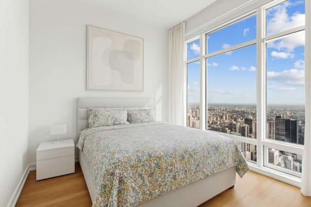 151 E 58th St Unit 42C, New York City, NY 10022 - bedroom featuring wood finished floors and baseboards
