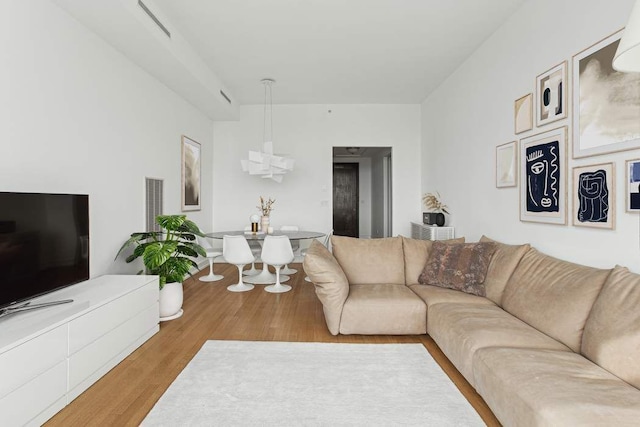 151 E 58th St Unit 42C, New York City, NY 10022 - living area featuring wood finished floors and a chandelier