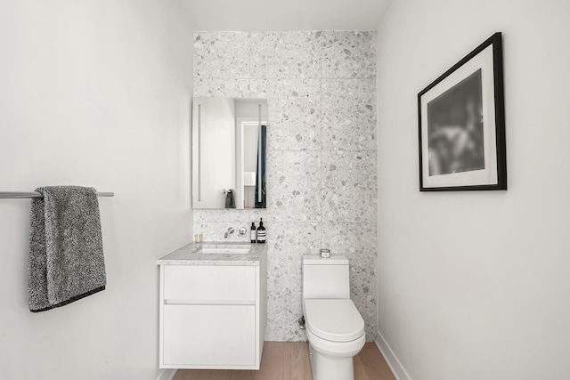 128 W 23rd St Unit 15B, New York City, NY 10011 - bathroom with vanity, toilet, and wood finished floors
