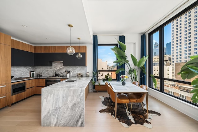 128 W 23rd St Unit 15B, New York City, NY 10011 - kitchen featuring modern cabinets, healthy amount of natural light, and a city view