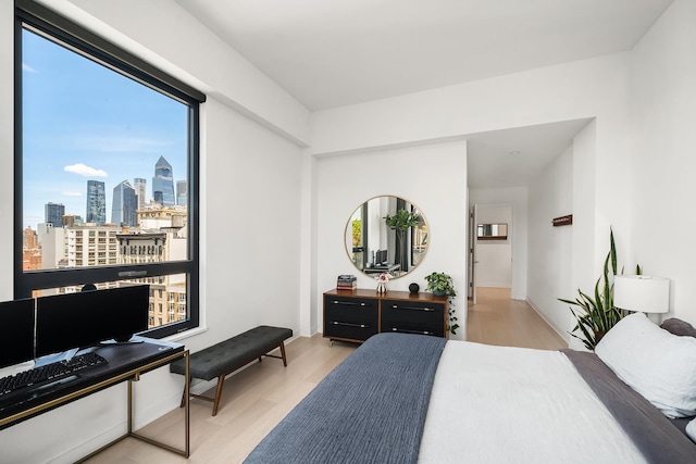 128 W 23rd St Unit 15B, New York City, NY 10011 - bedroom with multiple windows and wood finished floors