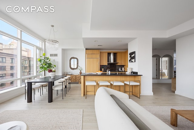 70 Little W St Unit 7L, New York City, NY 10004 - living room with light wood finished floors, a chandelier, and arched walkways