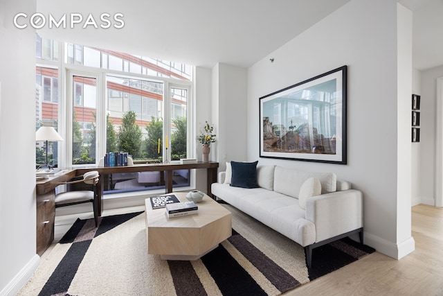 70 Little W St Unit 7L, New York City, NY 10004 - living area with light wood finished floors, healthy amount of natural light, and baseboards