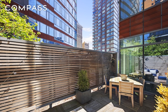 70 Little W St Unit 7L, New York City, NY 10004 - wooden terrace featuring outdoor dining space and a city view