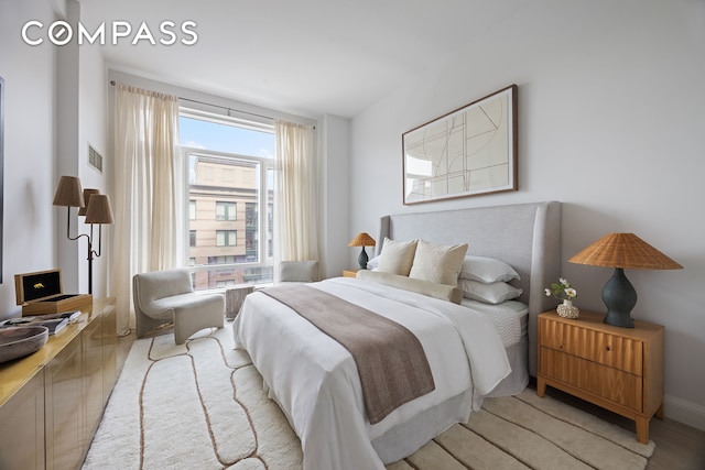 70 Little W St Unit 7L, New York City, NY 10004 - bedroom with light wood-style flooring and baseboards
