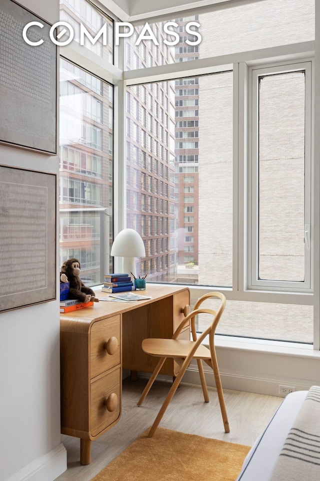 70 Little W St Unit 7L, New York City, NY 10004 - office area with wood finished floors and baseboards