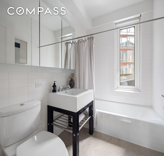 70 Little W St Unit 7L, New York City, NY 10004 - bathroom featuring toilet, shower / tub combo with curtain, tile walls, and vanity