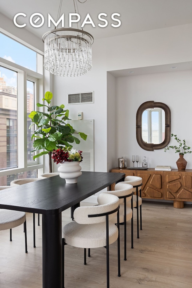 70 Little W St Unit 7L, New York City, NY 10004 - dining area featuring a chandelier and light wood finished floors
