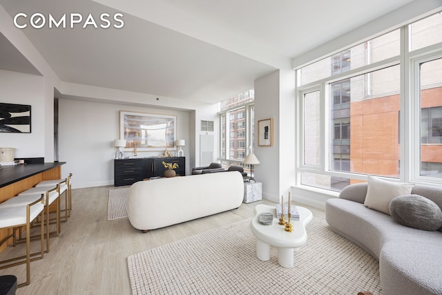 70 Little W St Unit 7L, New York City, NY 10004 - living area with light wood-style flooring and baseboards