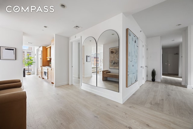 70 Little W St Unit 7L, New York City, NY 10004 - hallway featuring light wood-style floors and baseboards