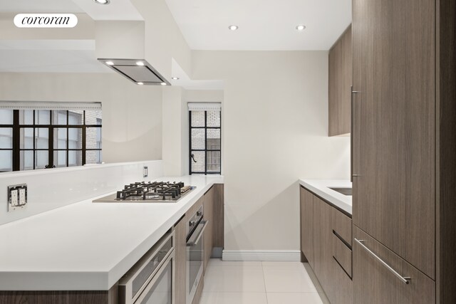 10 Park Ave Unit 3Ab, New York City, NY 10016 - kitchen with modern cabinets, stainless steel appliances, light countertops, baseboards, and light tile patterned floors