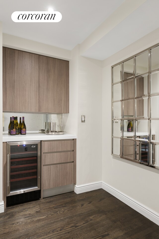 10 Park Ave Unit 3Ab, New York City, NY 10016 - indoor dry bar with beverage cooler, baseboards, and dark wood-type flooring