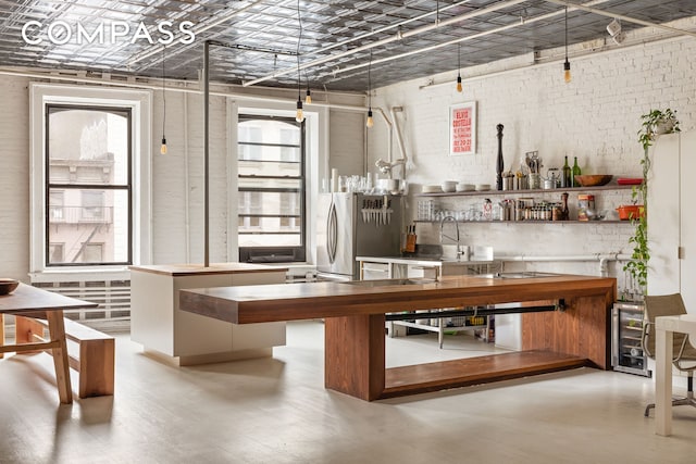 49 Howard St Unit 4S, New York City, NY 10013 - interior space with brick wall, plenty of natural light, an ornate ceiling, beverage cooler, and wood finished floors