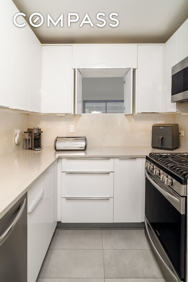 530 E 72nd St Unit 7C, New York City, NY 10021 - kitchen with stainless steel appliances, white cabinets, and modern cabinets