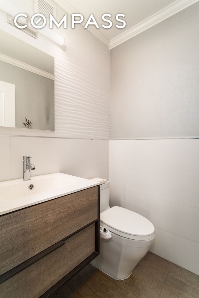 530 E 72nd St Unit 7C, New York City, NY 10021 - bathroom featuring tile walls, crown molding, vanity, and tile patterned flooring