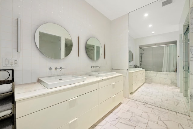 152 Wooster St Unit 2A, New York City, NY 10012 - bathroom featuring marble look tiles, a stall shower, double vanity, and recessed lighting