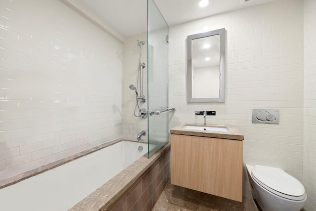152 Wooster St Unit 2A, New York City, NY 10012 - full bathroom with tiled shower / bath, vanity, tile walls, and toilet