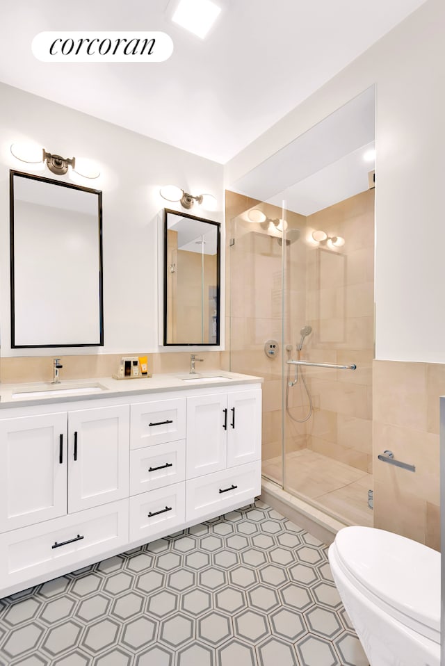 213 E 71st St Unit Ph5, New York City, NY 10021 - full bath featuring a stall shower, double vanity, and toilet