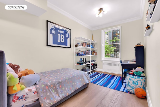 213 E 71st St Unit Ph5, New York City, NY 10021 - bedroom with radiator, wood finished floors, ornamental molding, and baseboards