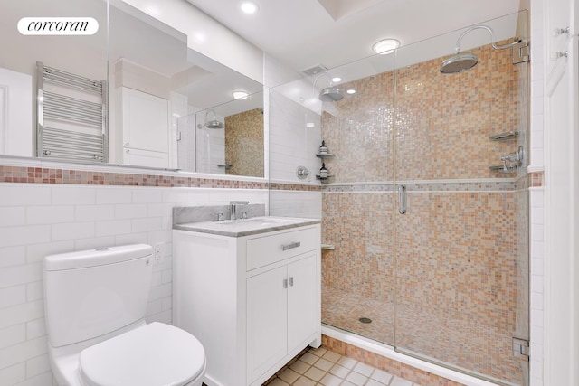 213 E 71st St Unit Ph5, New York City, NY 10021 - full bath featuring radiator, tile walls, a shower stall, vanity, and toilet