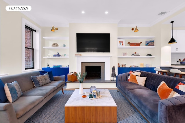 213 E 71st St Unit Ph5, New York City, NY 10021 - living room with built in shelves, ornamental molding, a fireplace with raised hearth, and recessed lighting