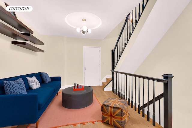 213 E 71st St Unit Ph5, New York City, NY 10021 - living area featuring light wood-style flooring, baseboards, stairway, and a chandelier