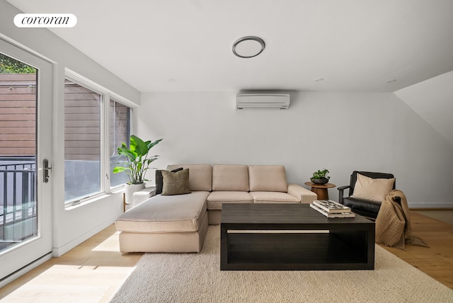 291 6th Ave Unit 1, New York City, NY 11215 - living room featuring an AC wall unit, light wood-style flooring, and plenty of natural light