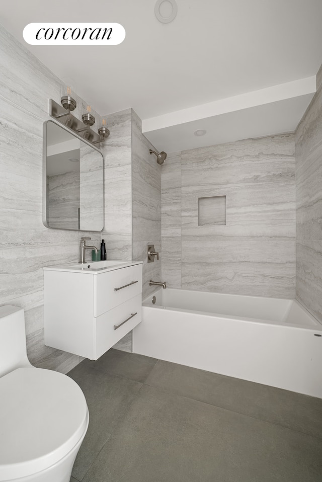 291 6th Ave Unit 1, New York City, NY 11215 - bathroom with washtub / shower combination, vanity, tile patterned floors, and tile walls