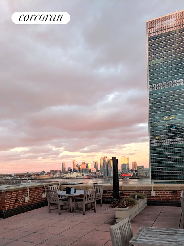 333 E 43rd St Unit 511, New York City, NY 10017 - patio terrace at dusk featuring a patio and a skyline view