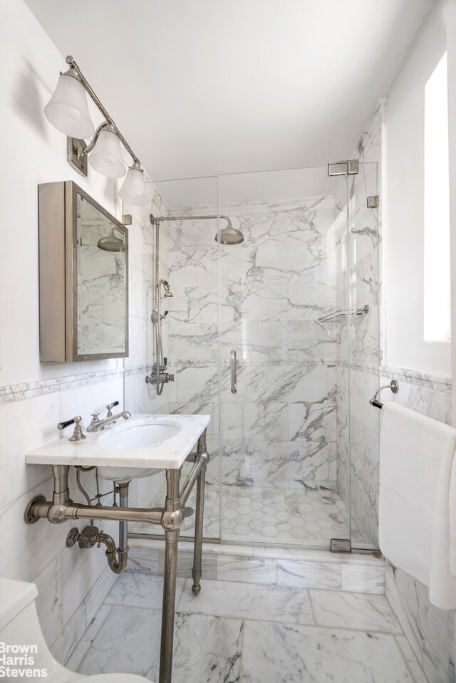 340 E 80th St Unit 17F, New York City, NY 10075 - full bathroom with tile walls, toilet, a marble finish shower, and marble finish flooring
