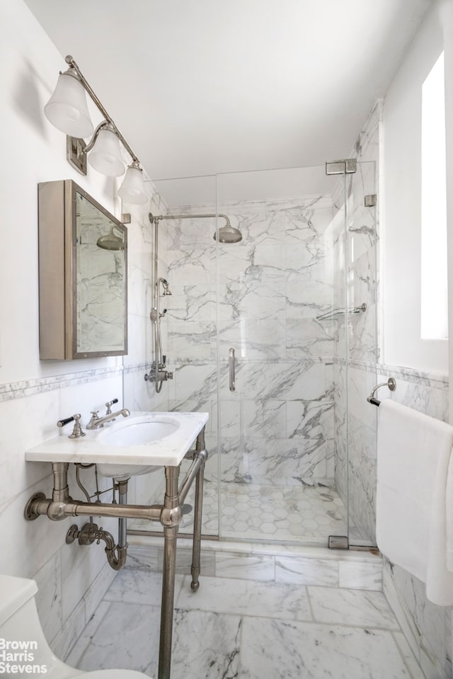 340 E 80th St Unit 17F, New York City, NY 10075 - full bathroom with tile walls, a marble finish shower, and marble look tiles