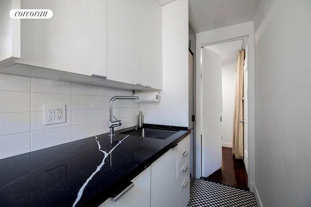 240 E 24th St Unit 4B, New York City, NY 10010 - kitchen featuring white cabinetry, backsplash, and a sink