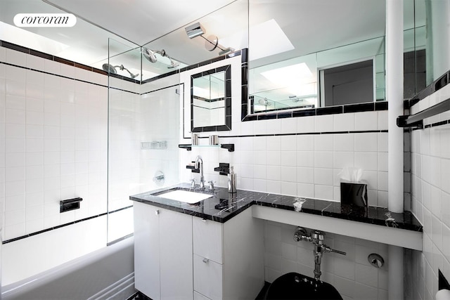 240 E 24th St Unit 4B, New York City, NY 10010 - bathroom with tile walls, backsplash, shower / bath combination, and vanity