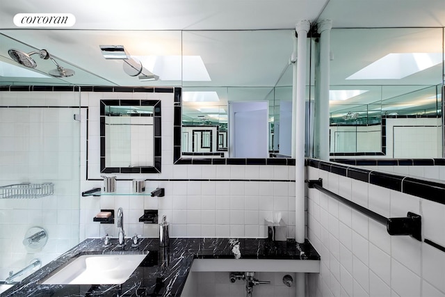 240 E 24th St Unit 4B, New York City, NY 10010 - full bath featuring a sink, tile walls, and tasteful backsplash