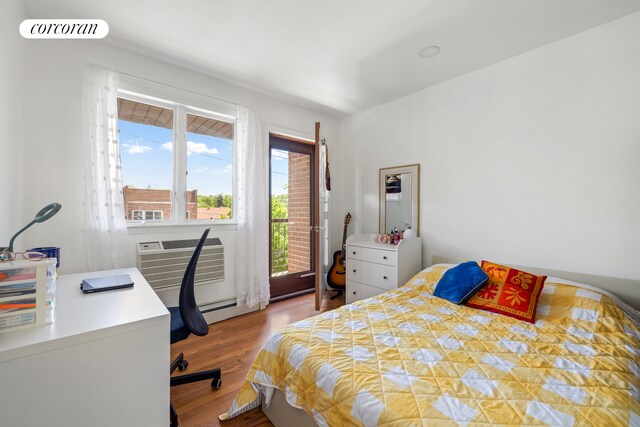 46-12 161st St Unit 3B, New York City, NY 11358 - bedroom featuring wood finished floors, a wall mounted air conditioner, and an office area