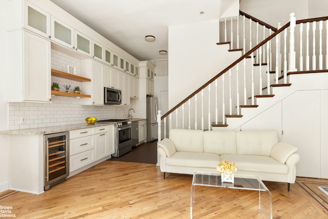 305 W 105th St Unit 2A/3A, New York City, NY 10025 - living area with beverage cooler, stairs, and light wood-style flooring
