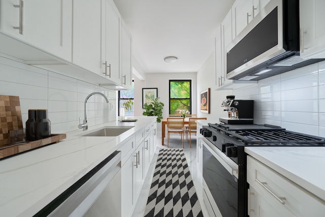 41-12 41st St Unit 2N, New York City, NY 11104 - kitchen featuring gas stove, stainless steel microwave, a sink, tile patterned floors, and decorative backsplash