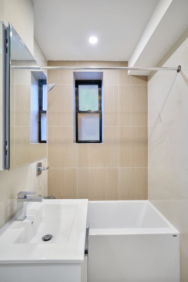 41-12 41st St Unit 2N, New York City, NY 11104 - bathroom with vanity, tile walls, bathtub / shower combination, and recessed lighting