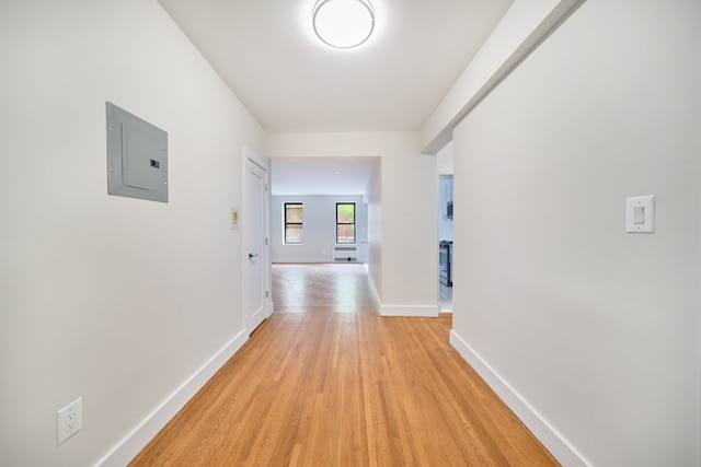 41-12 41st St Unit 2N, New York City, NY 11104 - corridor featuring electric panel, light wood-style floors, and baseboards
