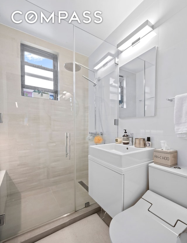 140 W 58th St Pha, Pha, New York City, NY 10019 - bathroom featuring toilet, a shower stall, and vanity