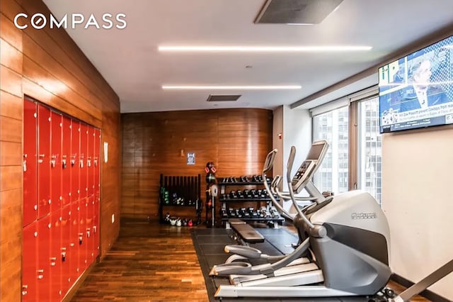 75 Wall St Unit 27F, New York City, NY 10005 - exercise room with wooden walls and wood finished floors