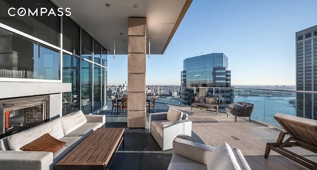 75 Wall St Unit 27F, New York City, NY 10005 - balcony featuring an outdoor living space and a view of city