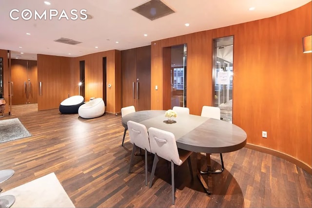 75 Wall St Unit 27F, New York City, NY 10005 - dining area with wood finished floors, wood walls, and recessed lighting