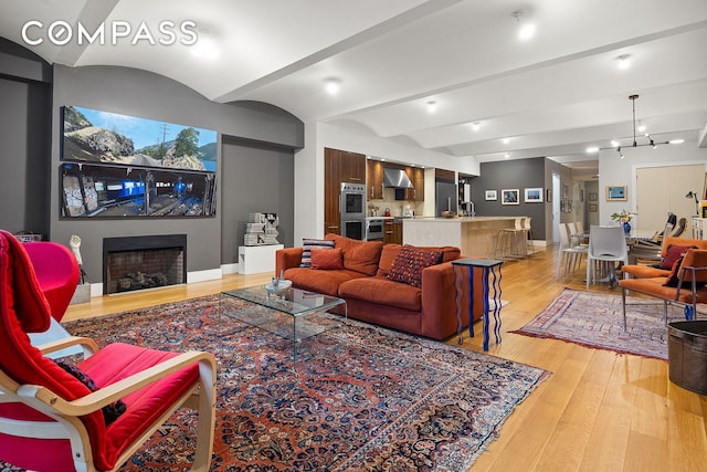 42 Ann St Unit 7, New York City, NY 10038 - living room with light wood-style floors, a fireplace, wet bar, and baseboards