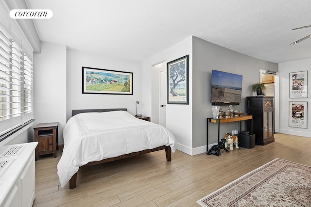 520 E 81st St Unit 8A, New York City, NY 10028 - bedroom with light wood-style flooring and baseboards