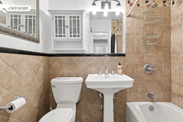 520 E 81st St Unit 8A, New York City, NY 10028 - bathroom with tile walls, toilet, and  shower combination