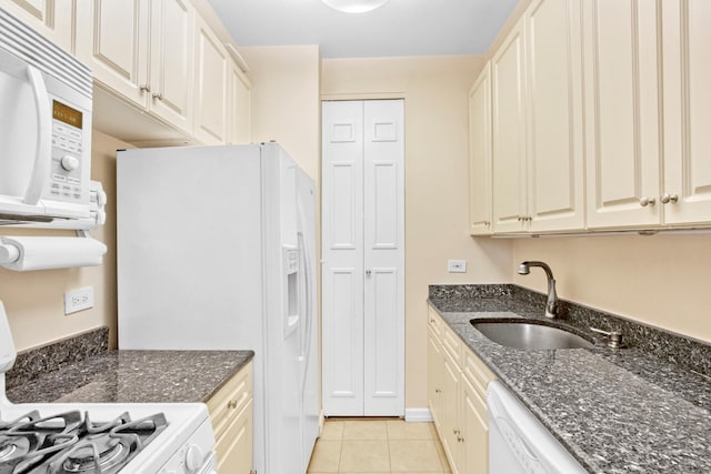 167 E 61st St Unit 11B, New York City, NY 10065 - kitchen featuring white appliances, a sink, light tile patterned floors, and dark stone counters