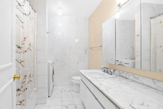 167 E 61st St Unit 11B, New York City, NY 10065 - bathroom featuring marble look tile flooring, vanity, toilet, and washer / clothes dryer