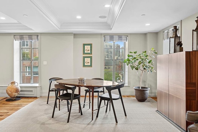 140 E 63rd St Unit 11C, New York City, NY 10065 - dining space featuring light wood-style floors, a tray ceiling, ornamental molding, baseboards, and recessed lighting