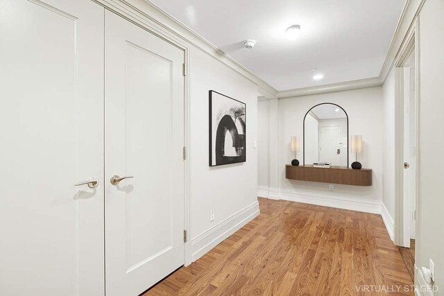 140 E 63rd St Unit 11C, New York City, NY 10065 - hall with baseboards, crown molding, and light wood finished floors